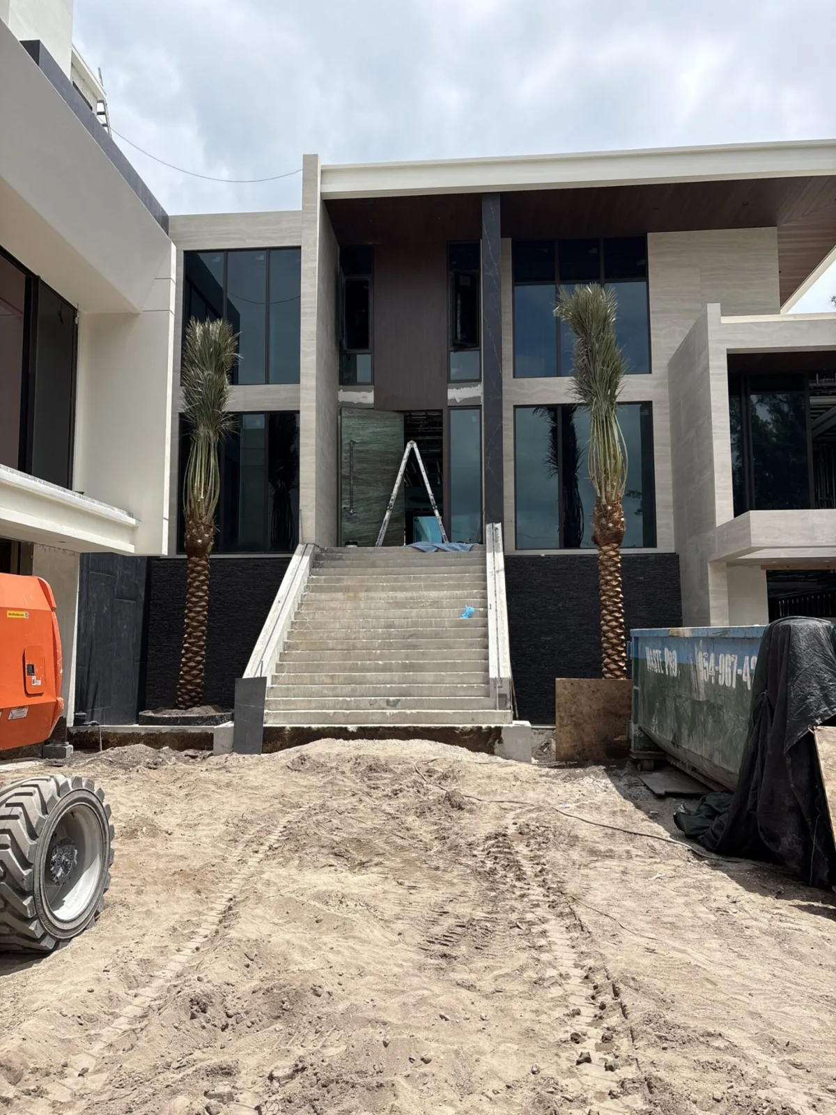 Palm trees being harvested, transported and placed on properties.